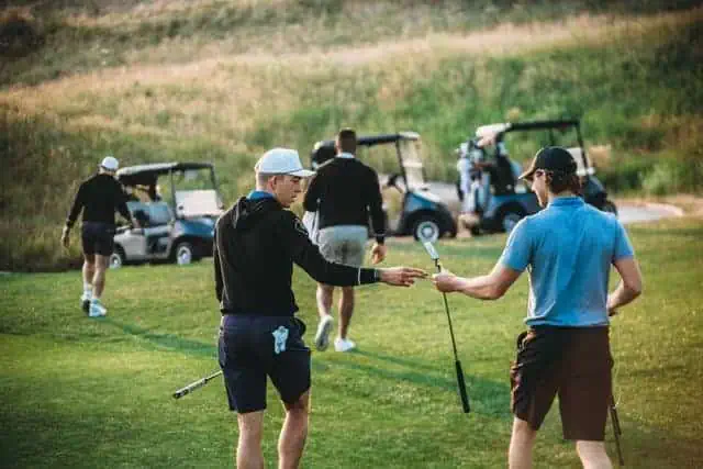 people golfing together